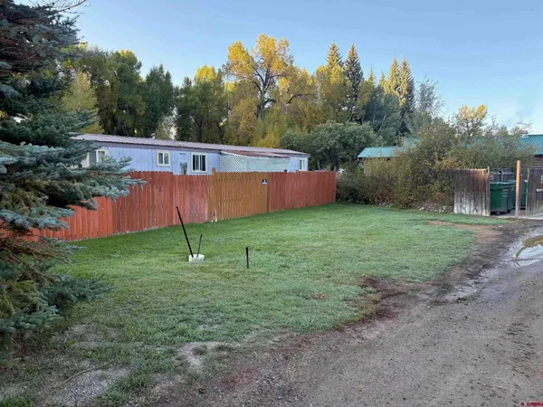 a view of a backyard with trees