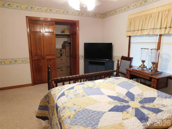 an empty room with windows and closet