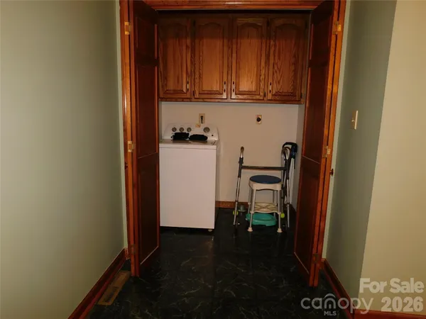 a room with a table chairs and a ceiling fan