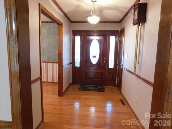 a view of entryway with a front door and wooden floor