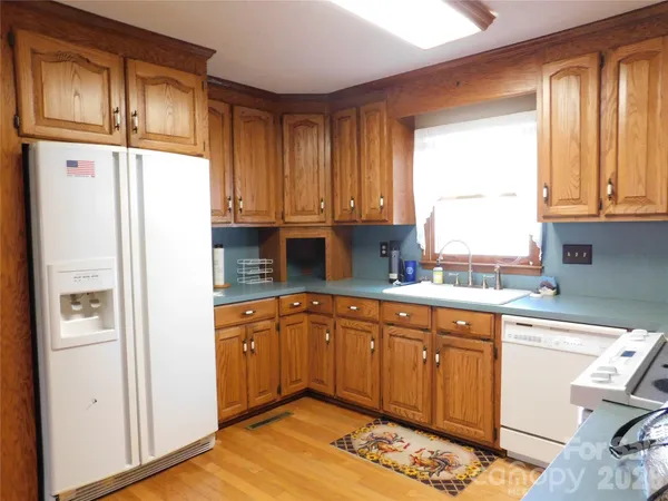 a kitchen with stainless steel appliances granite countertop a refrigerator sink and cabinets