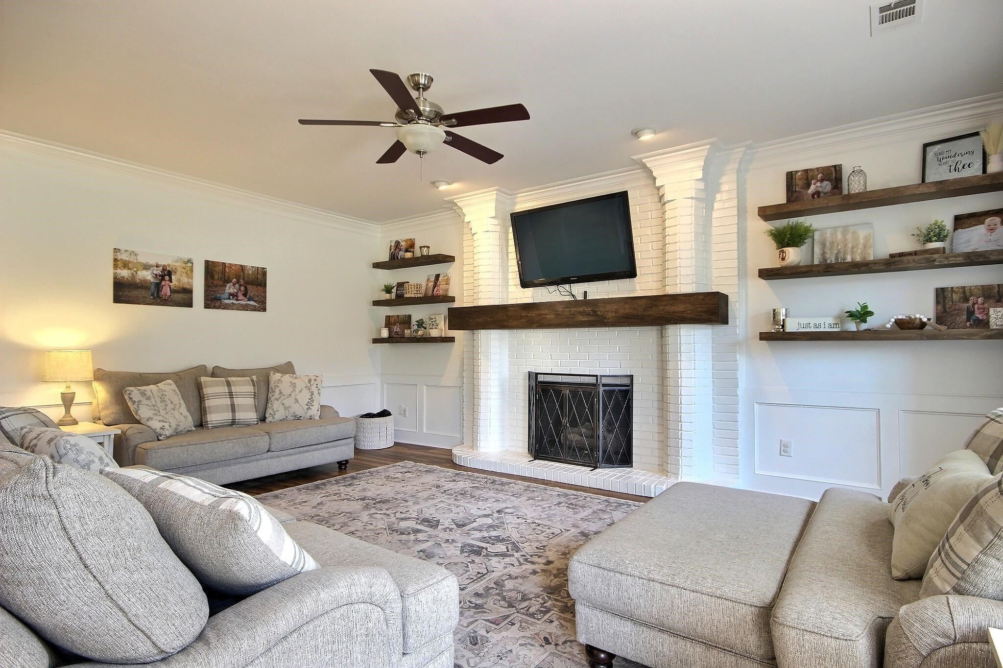 705 Cotham Drive Collierville, TN 38017 - Photo 2 of 25 a living room with furniture a flat screen tv and a fireplace