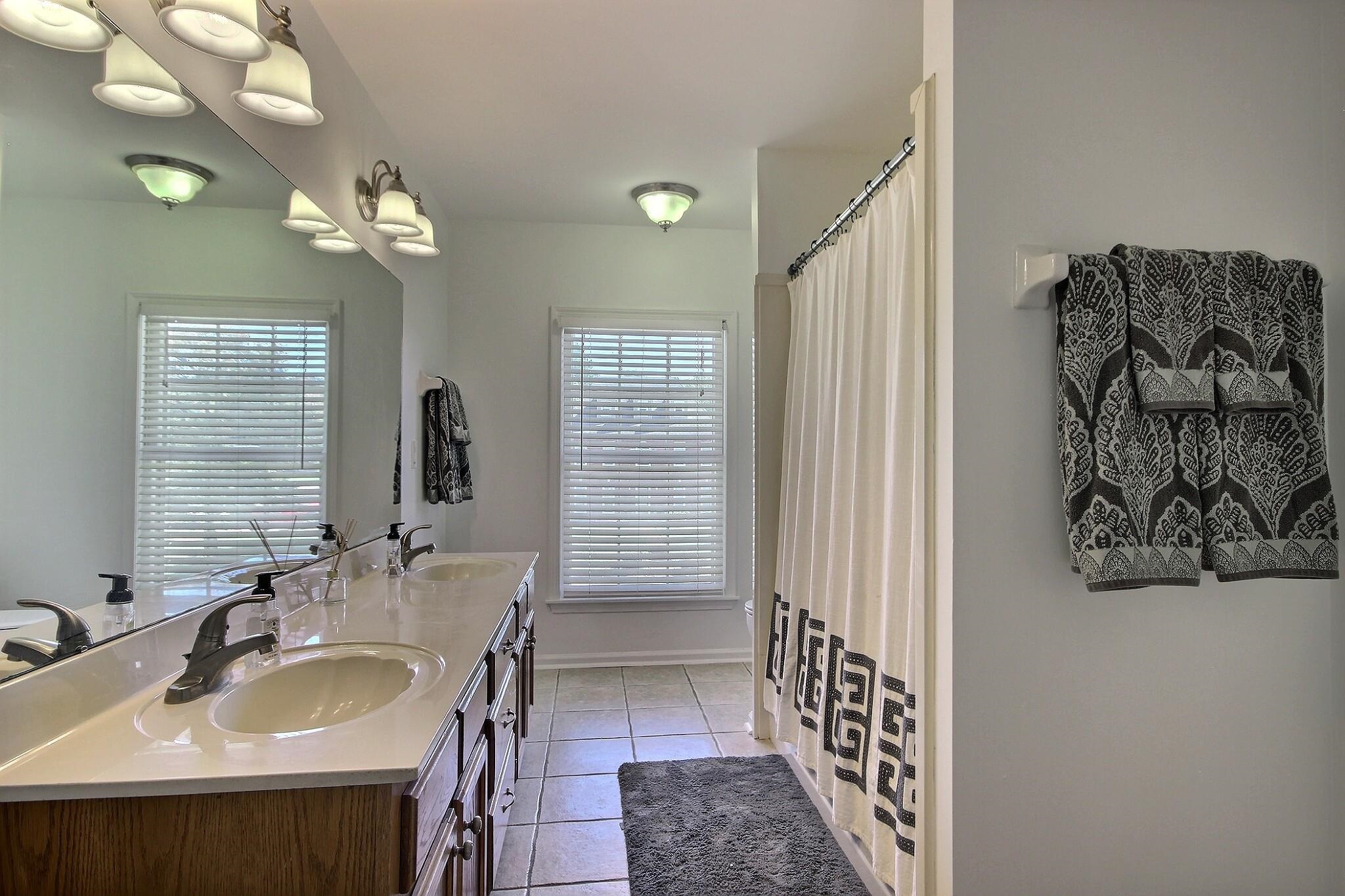 705 Cotham Drive Collierville, TN 38017 - Photo 21 of 25 a bathroom with a sink double vanity and a mirror