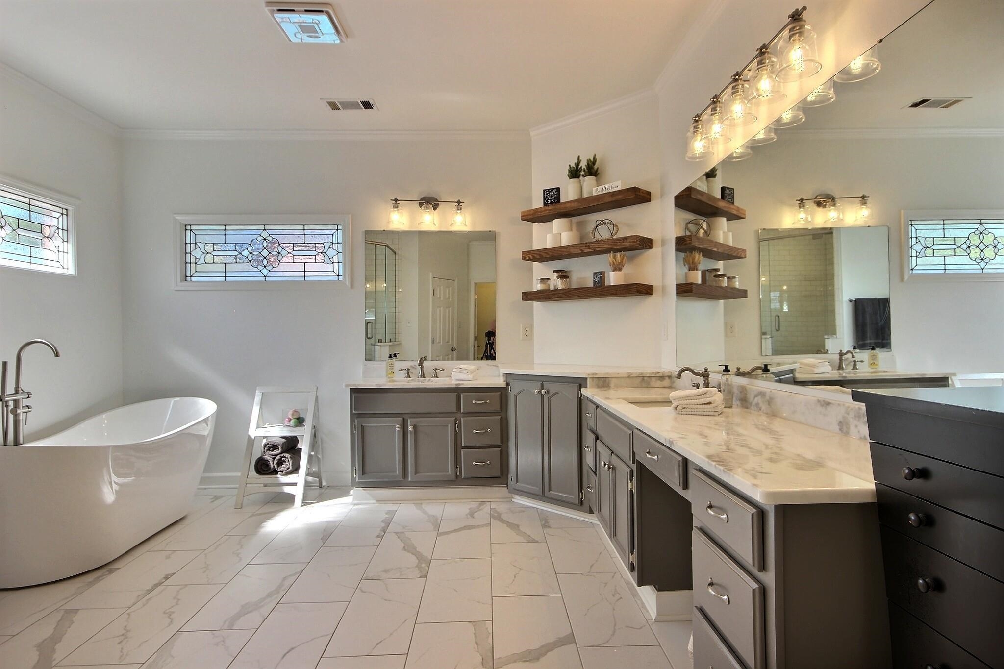 705 Cotham Drive Collierville, TN 38017 - Photo 10 of 25 a spacious bathroom with a granite countertop sink a toilet a mirror and bathtub