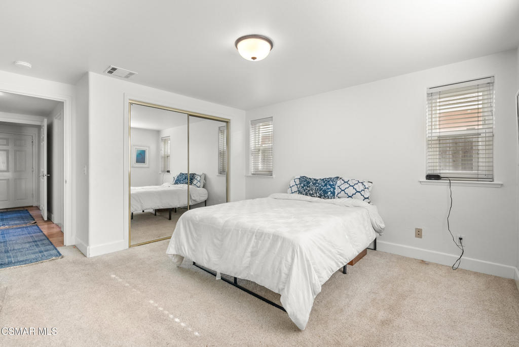 5138 Outrigger Way, Unit 1 Oxnard, CA 93035 - Photo 14 of 20 a bedroom with bed and a night stand