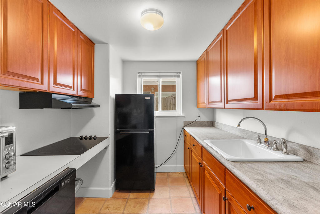 5138 Outrigger Way, Unit 1 Oxnard, CA 93035 - Photo 5 of 20 a kitchen with a sink a refrigerator and cabinets