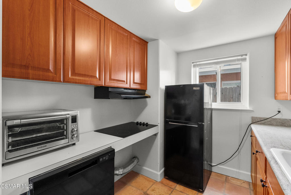 5138 Outrigger Way, Unit 1 Oxnard, CA 93035 - Photo 6 of 20 a kitchen with a refrigerator stove and cabinets