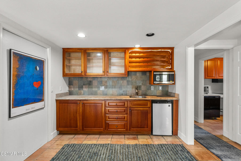 5138 Outrigger Way, Unit 1 Oxnard, CA 93035 - Photo 9 of 20 a kitchen with granite countertop a stove and cabinets