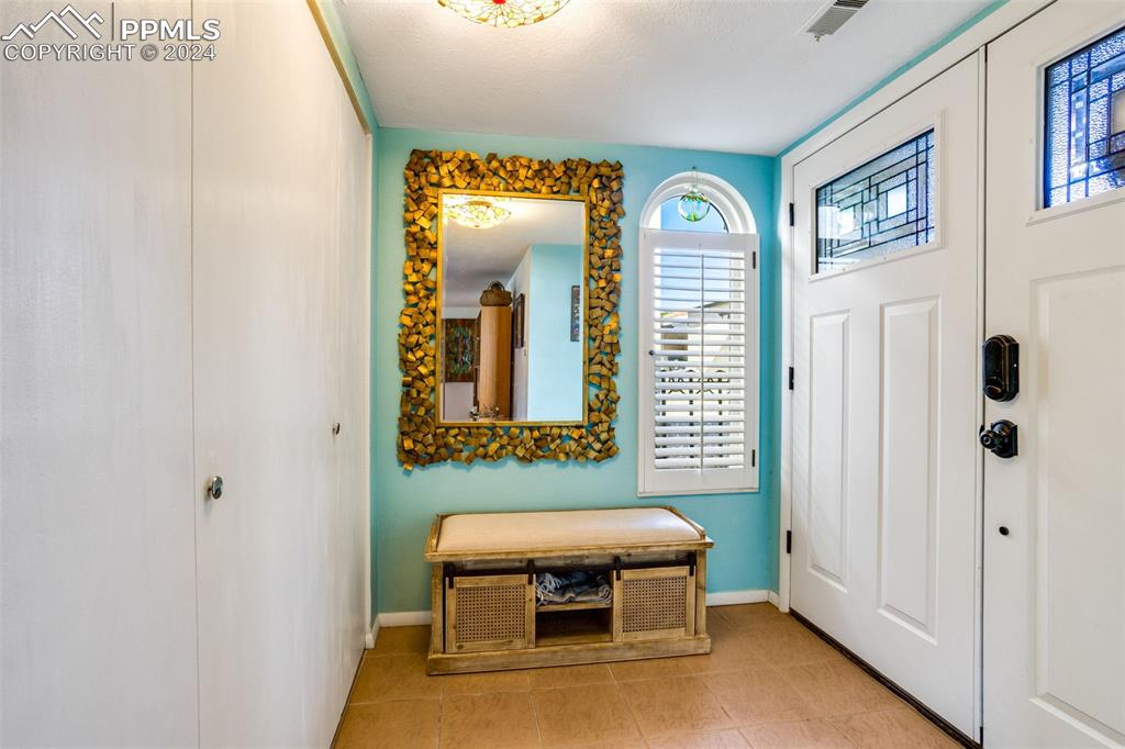 1098 Fontmore Road, Unit B Colorado Springs, CO 80904 - Photo 2 of 27 Entryway featuring light tile patterned flooring and a textured ceiling