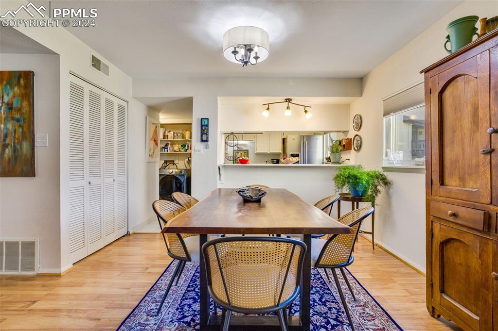 1098 Fontmore Road, Unit B Colorado Springs, CO 80904 - Photo 7 of 27 Dining area featuring washer and clothes dryer and light hardwood / wood-style flooring