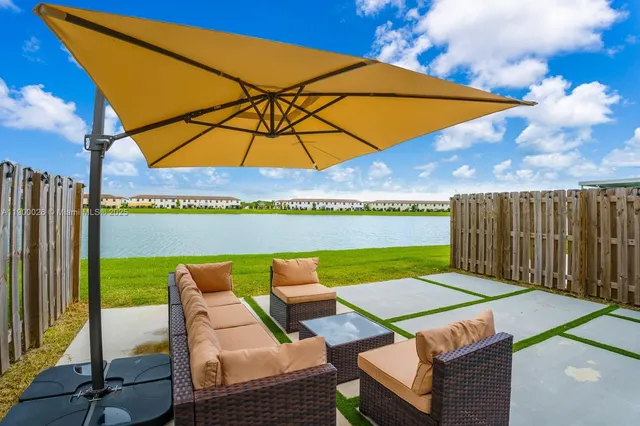 a view of a chairs and table in the backyard