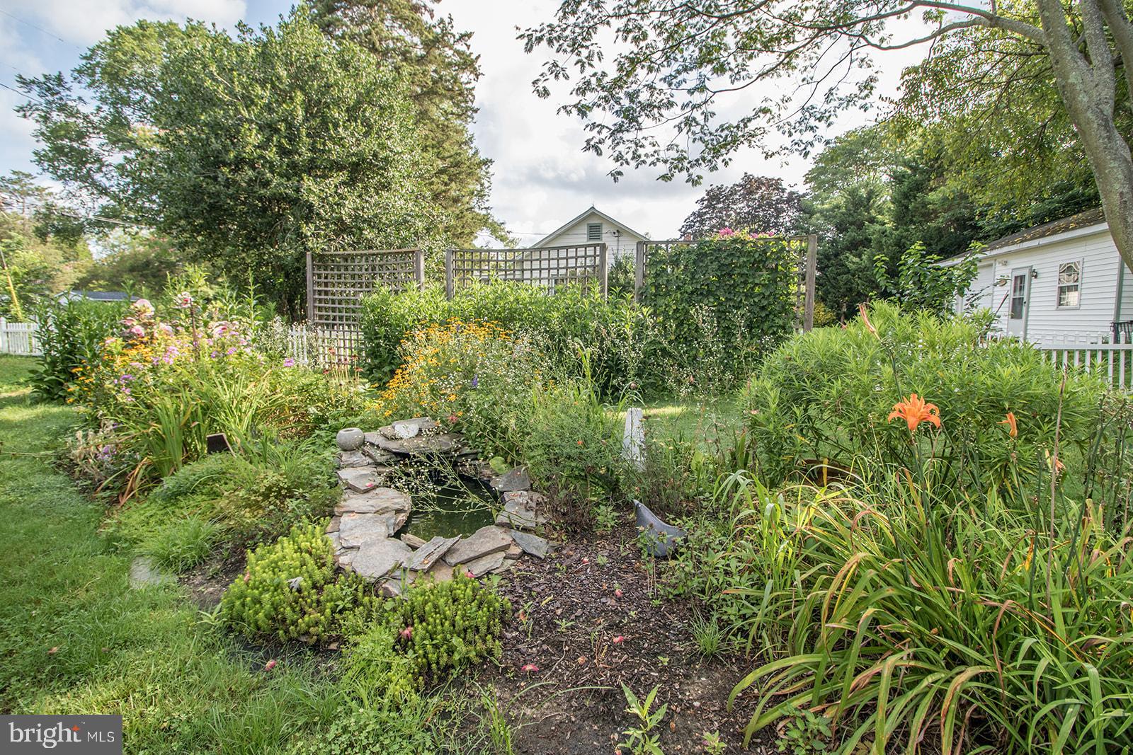 45044 Deagles Boatyard Road Tall Timbers, MD 20690 - Photo 13 of 64 a view of a garden with plants and large trees