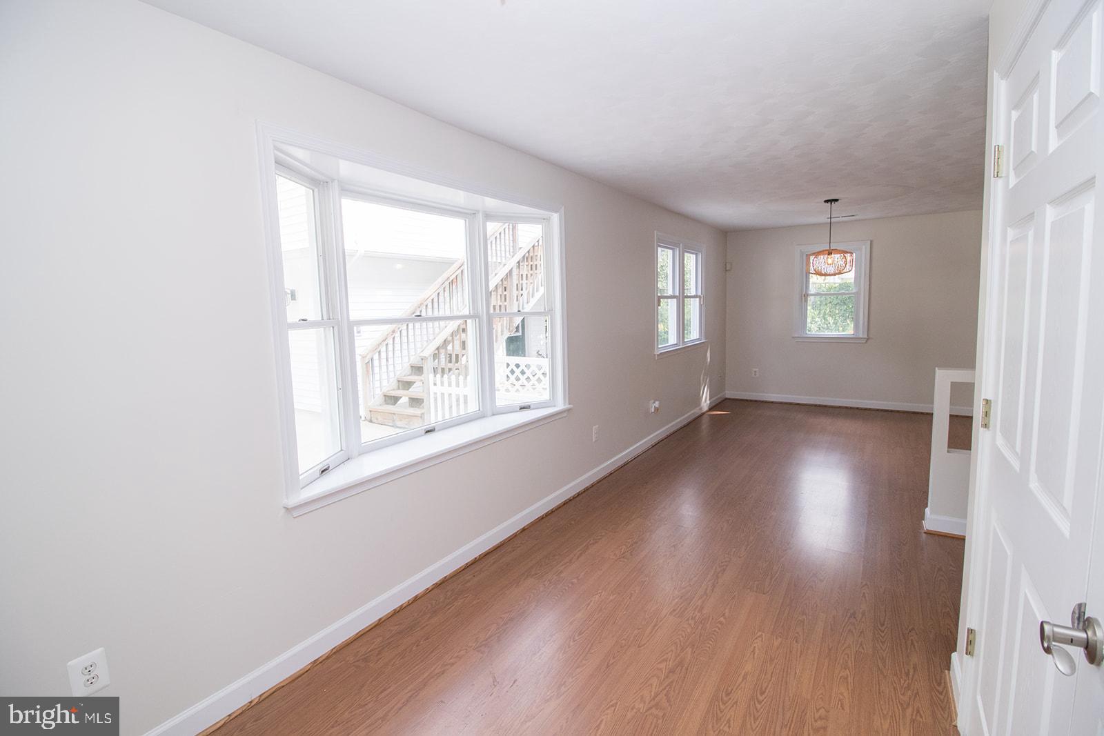 45044 Deagles Boatyard Road Tall Timbers, MD 20690 - Photo 19 of 64 an empty room with wooden floor and windows