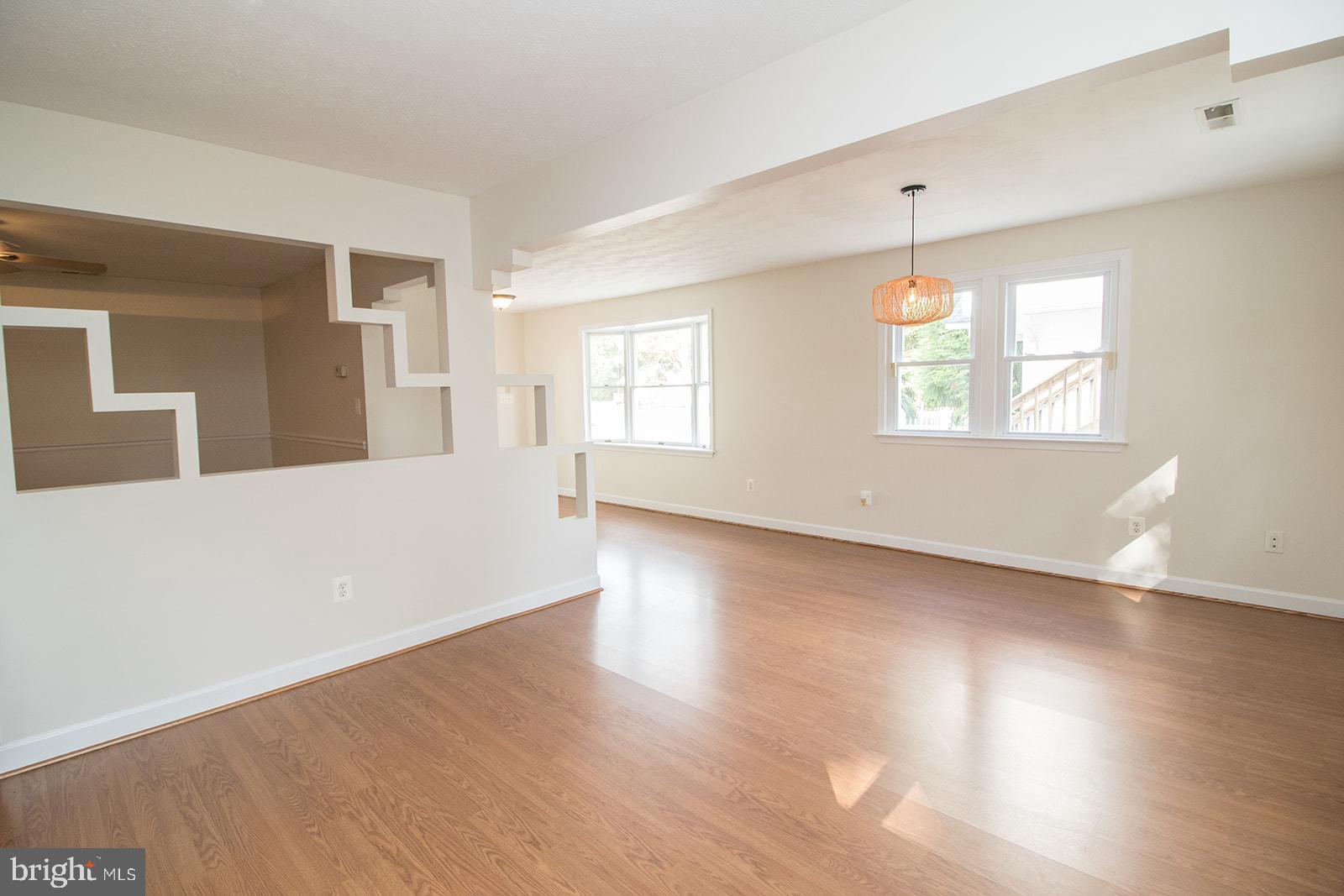 45044 Deagles Boatyard Road Tall Timbers, MD 20690 - Photo 21 of 64 an empty room with wooden floor and windows