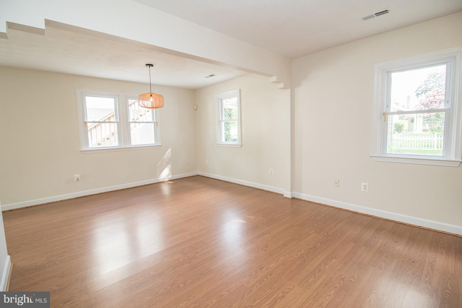 45044 Deagles Boatyard Road Tall Timbers, MD 20690 - Photo 22 of 64 an empty room with wooden floor and windows
