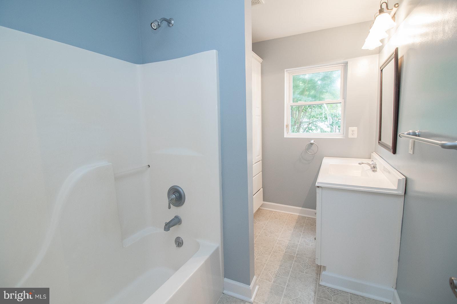 45044 Deagles Boatyard Road Tall Timbers, MD 20690 - Photo 25 of 64 a bathroom with a bathtub sink and mirror