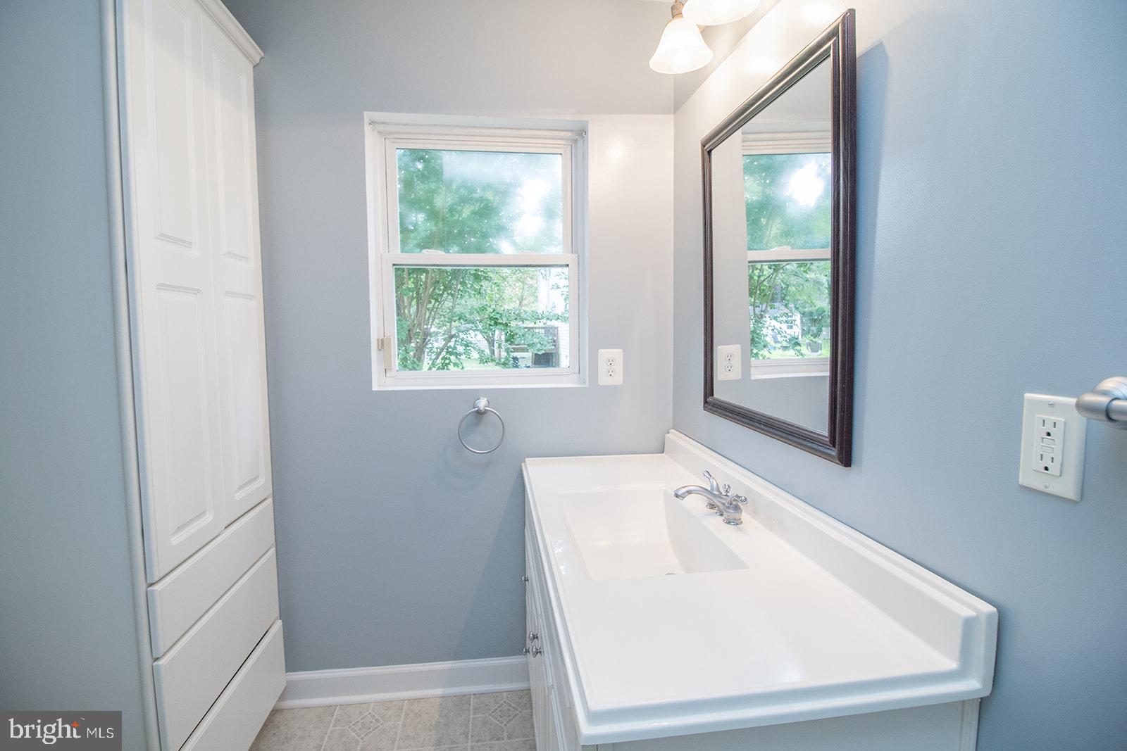 45044 Deagles Boatyard Road Tall Timbers, MD 20690 - Photo 26 of 64 a white bath tub sitting in a bathroom next to a window