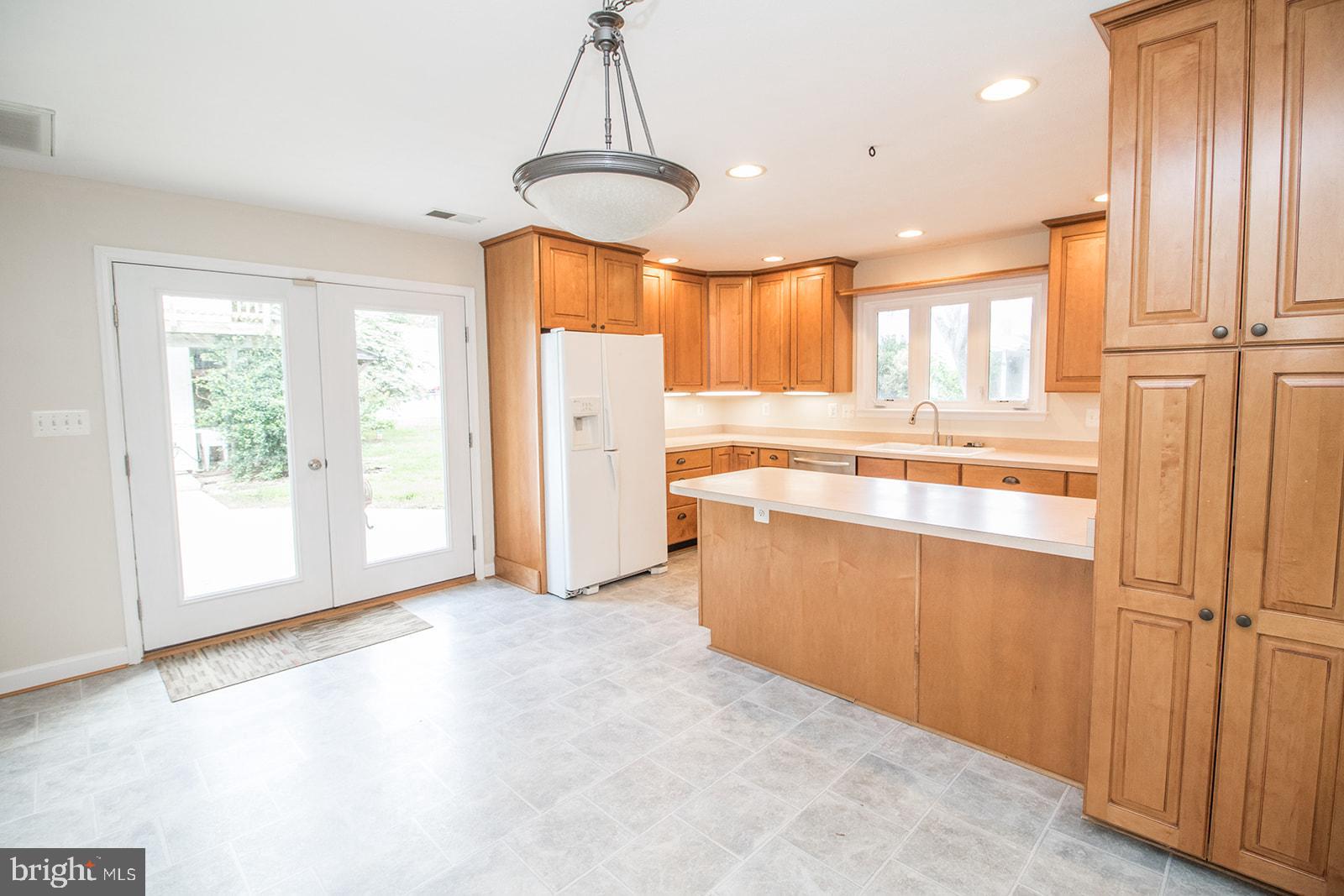 45044 Deagles Boatyard Road Tall Timbers, MD 20690 - Photo 29 of 64 a kitchen with stainless steel appliances granite countertop a refrigerator a sink and a stove