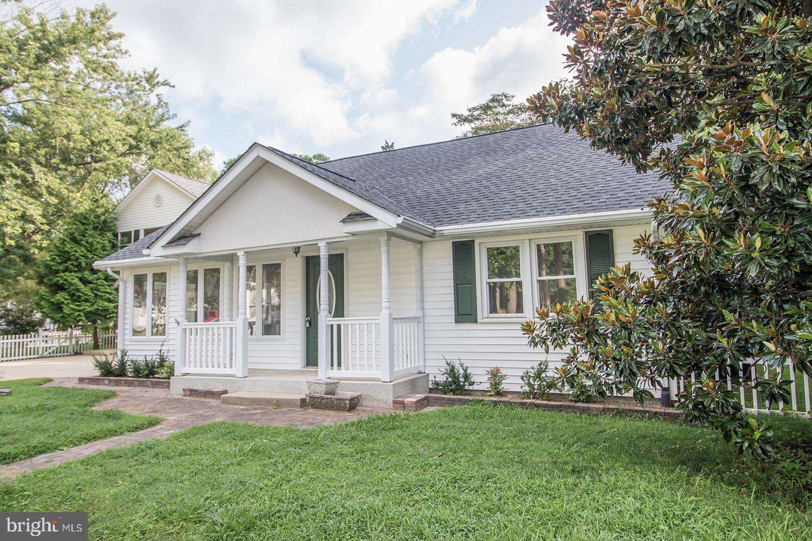 45044 Deagles Boatyard Road Tall Timbers, MD 20690 - Photo 3 of 64 a front view of a house with a garden and yard
