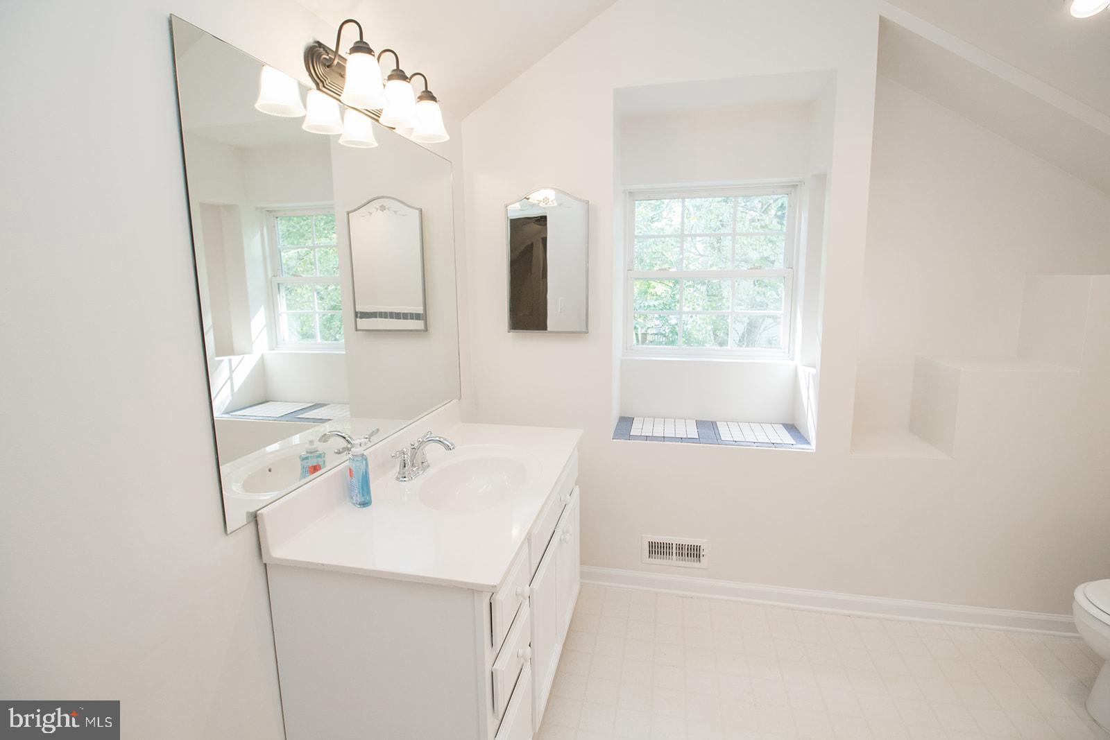 45044 Deagles Boatyard Road Tall Timbers, MD 20690 - Photo 47 of 64 a bathroom with a sink a mirror and a window