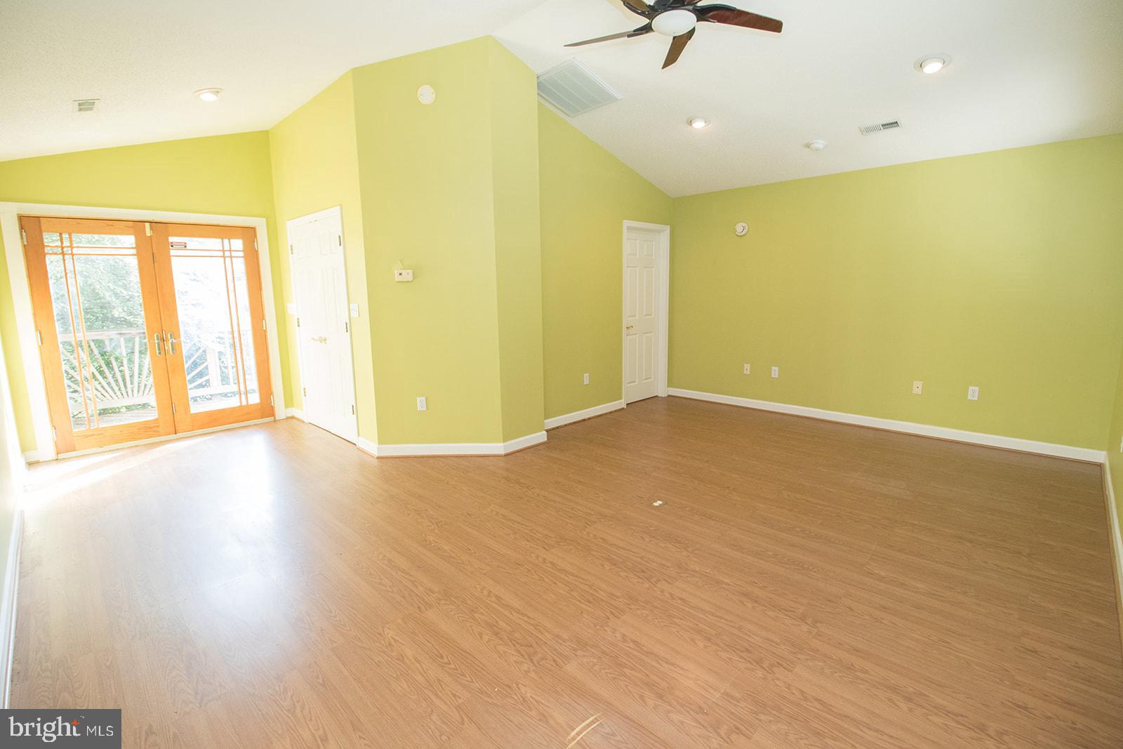 45044 Deagles Boatyard Road Tall Timbers, MD 20690 - Photo 54 of 64 an empty room with wooden floor and windows