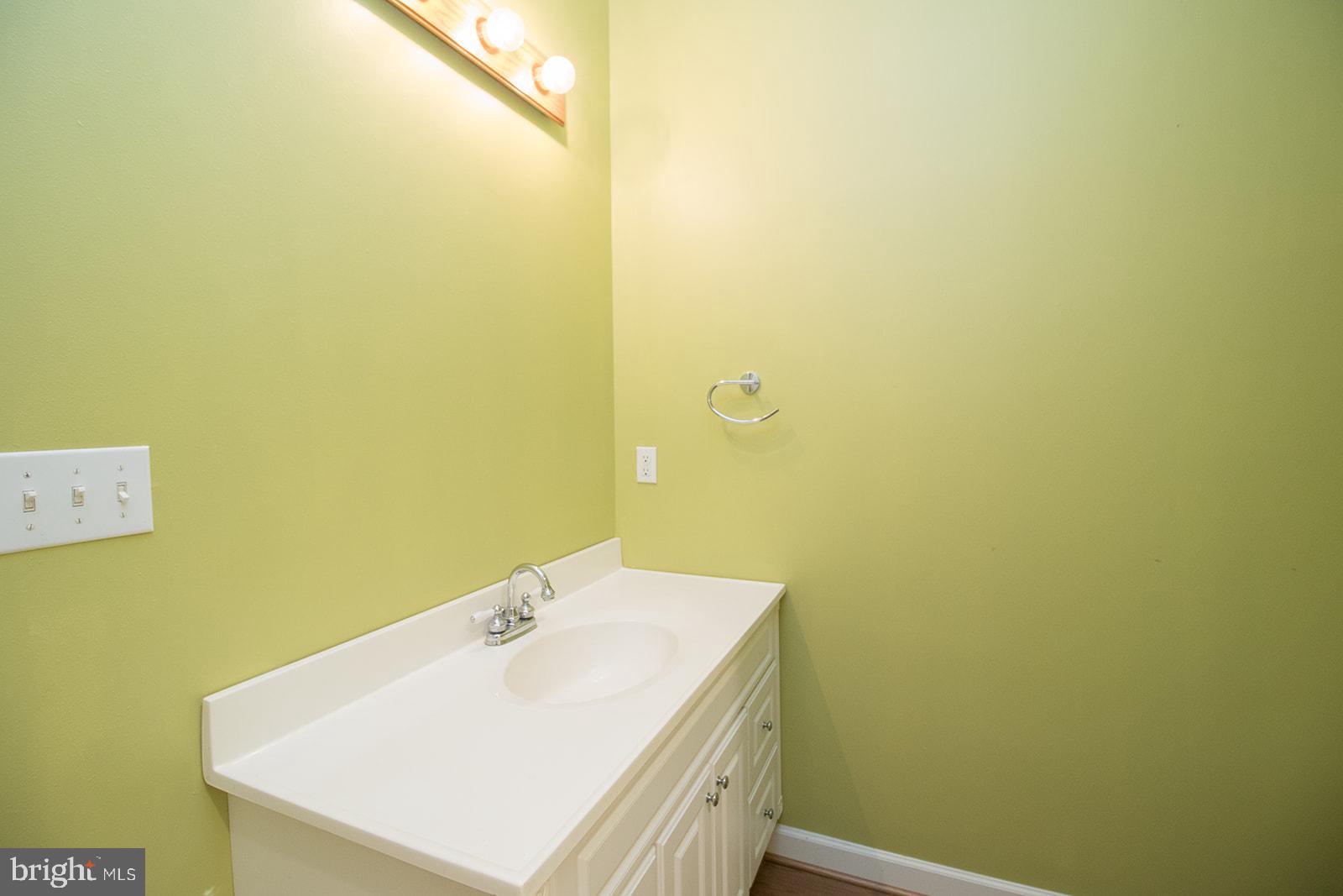 45044 Deagles Boatyard Road Tall Timbers, MD 20690 - Photo 57 of 64 a bathroom with a sink and a mirror
