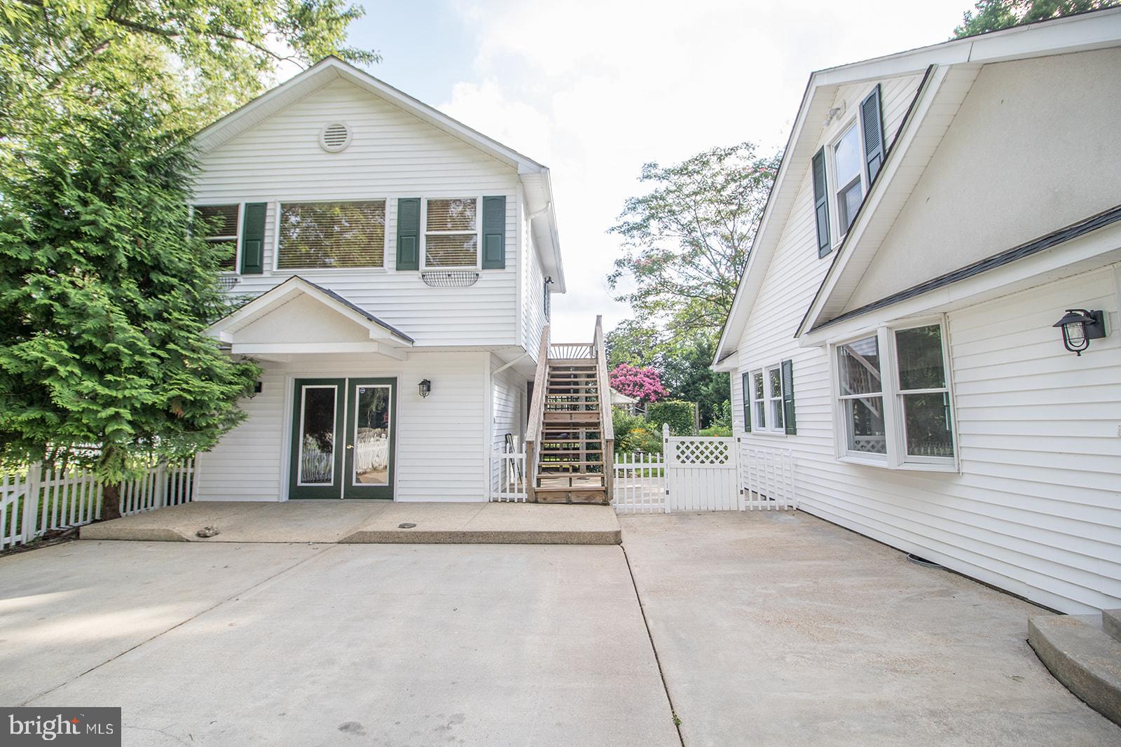 45044 Deagles Boatyard Road Tall Timbers, MD 20690 - Photo 7 of 64 a front view of a house with a garage