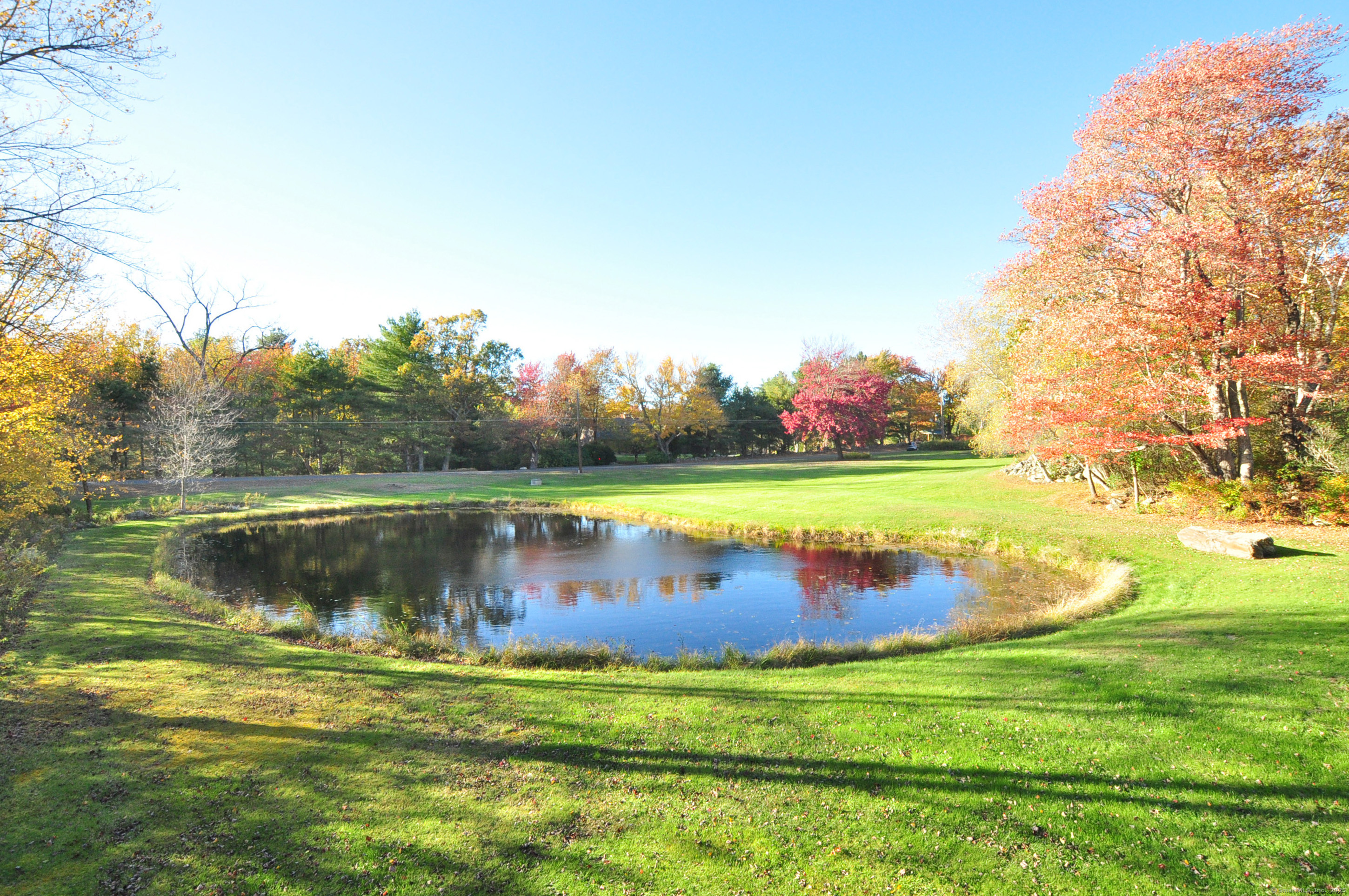 86 Case Street Granby, CT 06090 - Photo 6 of 25 a view of a golf course with a lake view