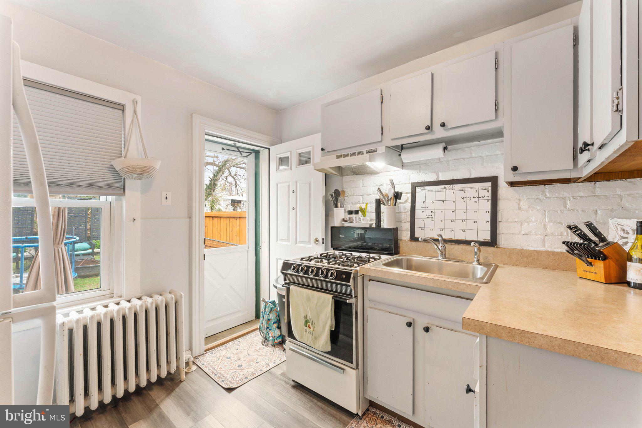 4823 Tibben Street Philadelphia, PA 19128 - Photo 11 of 28 a kitchen with a sink stove and cabinets