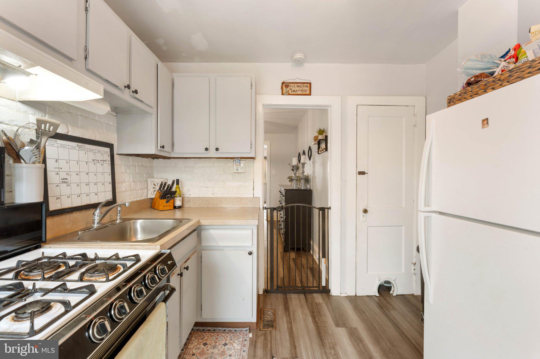 4823 Tibben Street Philadelphia, PA 19128 - Photo 13 of 28 a kitchen with stainless steel appliances granite countertop a refrigerator and a stove