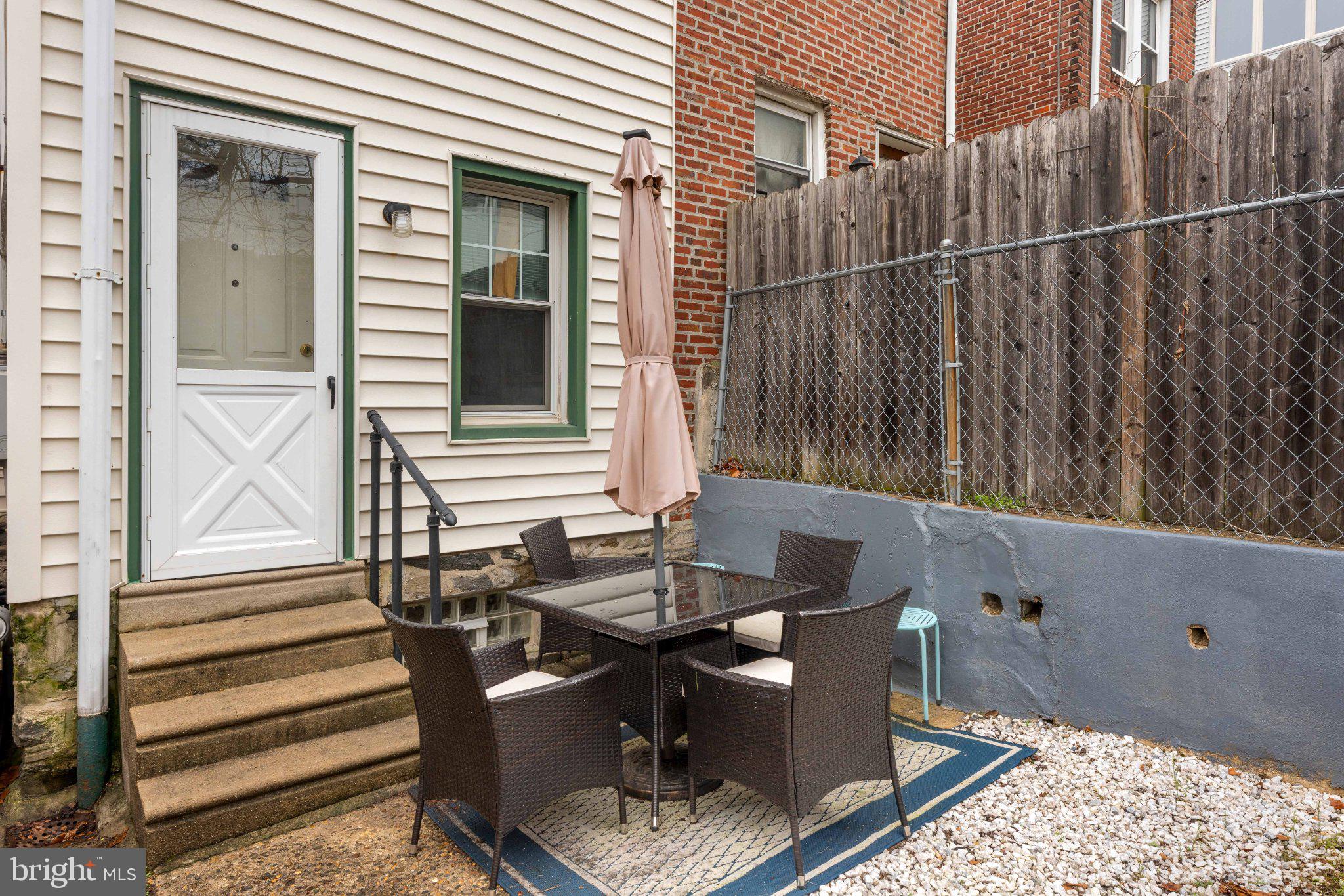 4823 Tibben Street Philadelphia, PA 19128 - Photo 16 of 28 a view of a patio with a table and chairs