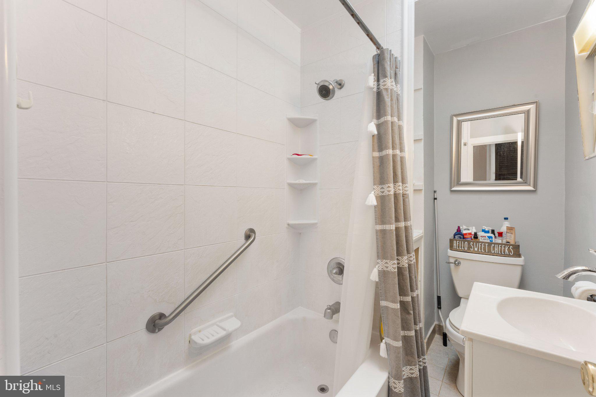 4823 Tibben Street Philadelphia, PA 19128 - Photo 23 of 28 a bathroom with a sink a toilet and shower