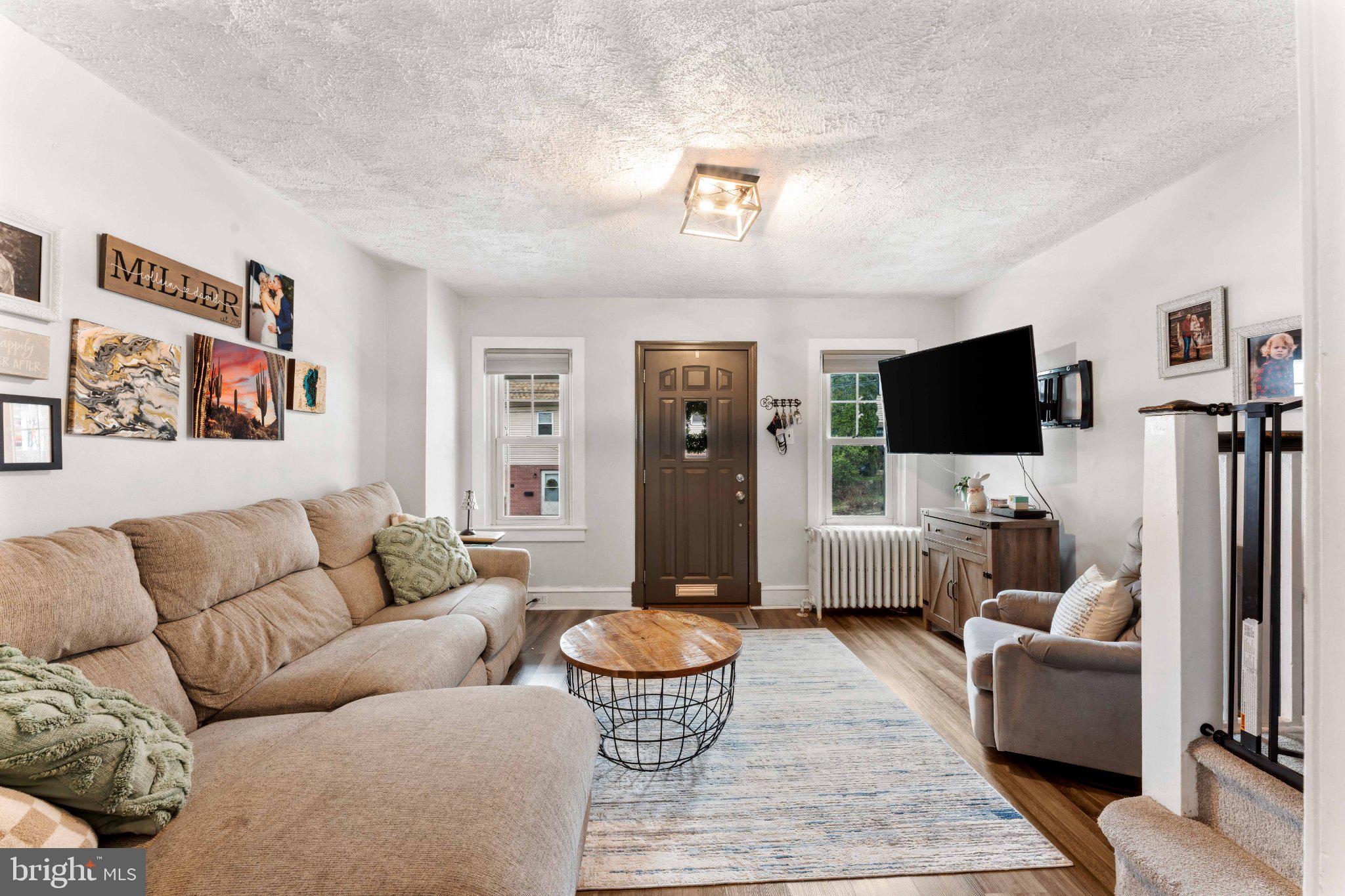 4823 Tibben Street Philadelphia, PA 19128 - Photo 4 of 28 a living room with furniture and a flat screen tv