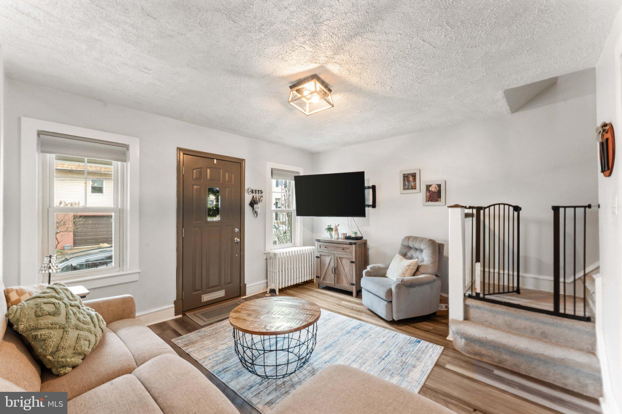 4823 Tibben Street Philadelphia, PA 19128 - Photo 5 of 28 a living room with furniture and a flat screen tv