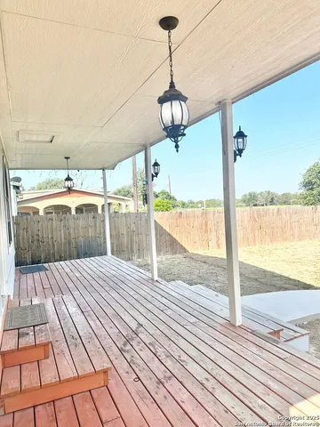a view of a balcony with wooden floor