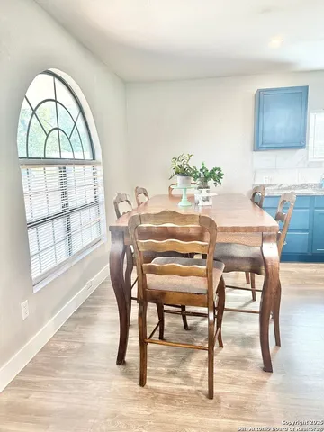 a dining room with furniture and window