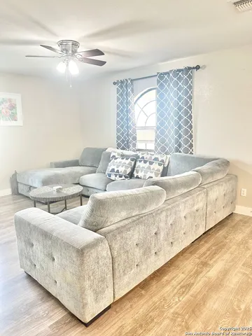 a living room with furniture and a large window