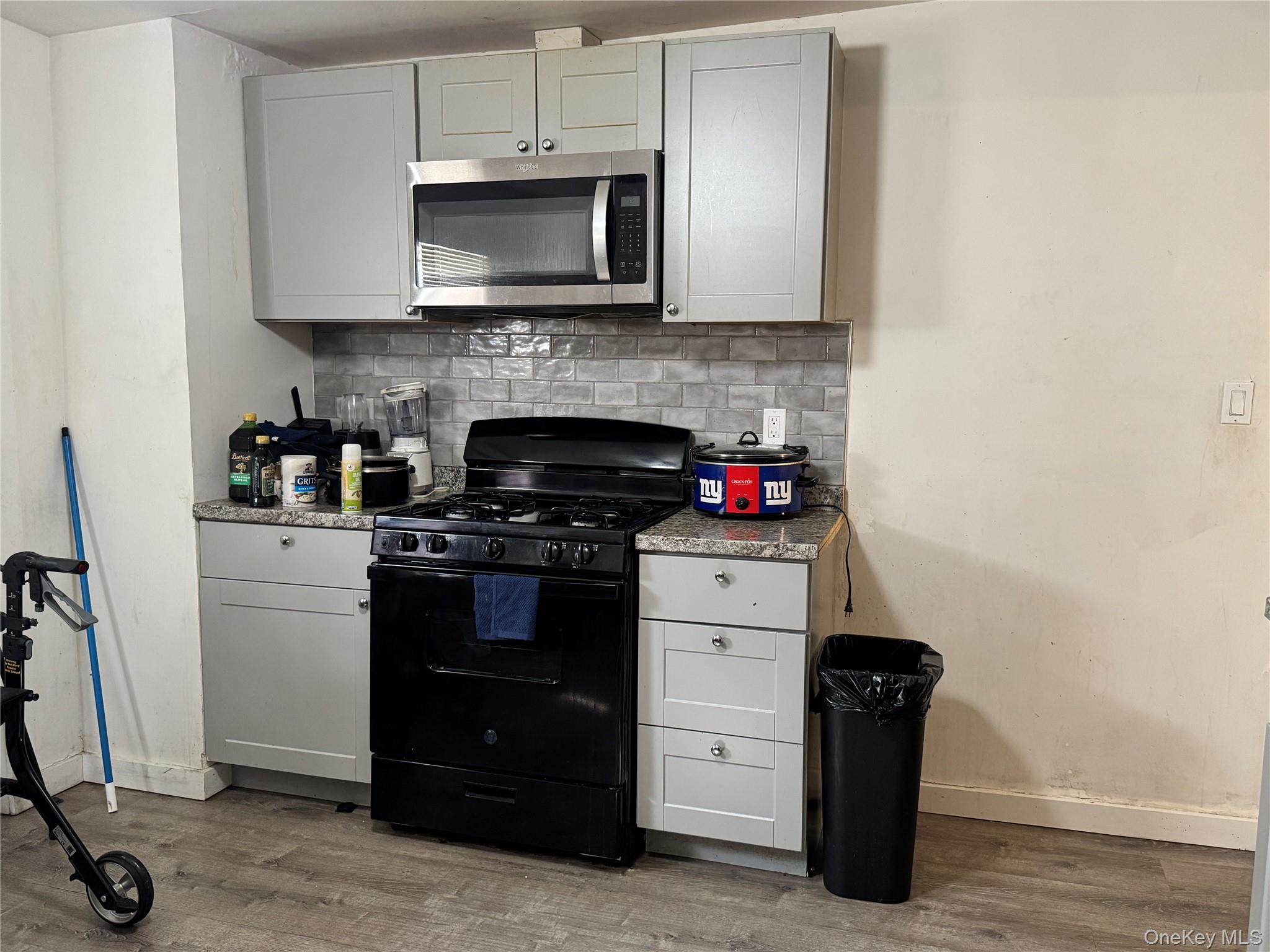 58 State Street Ossining, NY 10562 - Photo 11 of 11 a kitchen with a stove and a microwave