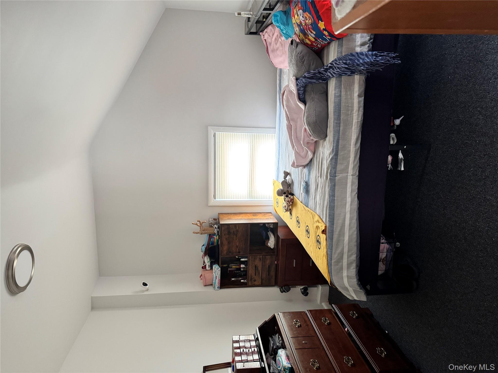 58 State Street Ossining, NY 10562 - Photo 4 of 11 a bedroom with a bed and a dresser