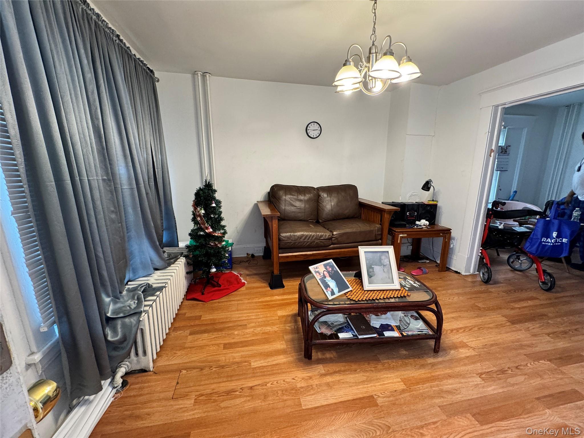 58 State Street Ossining, NY 10562 - Photo 7 of 11 a bedroom with furniture and a chandelier