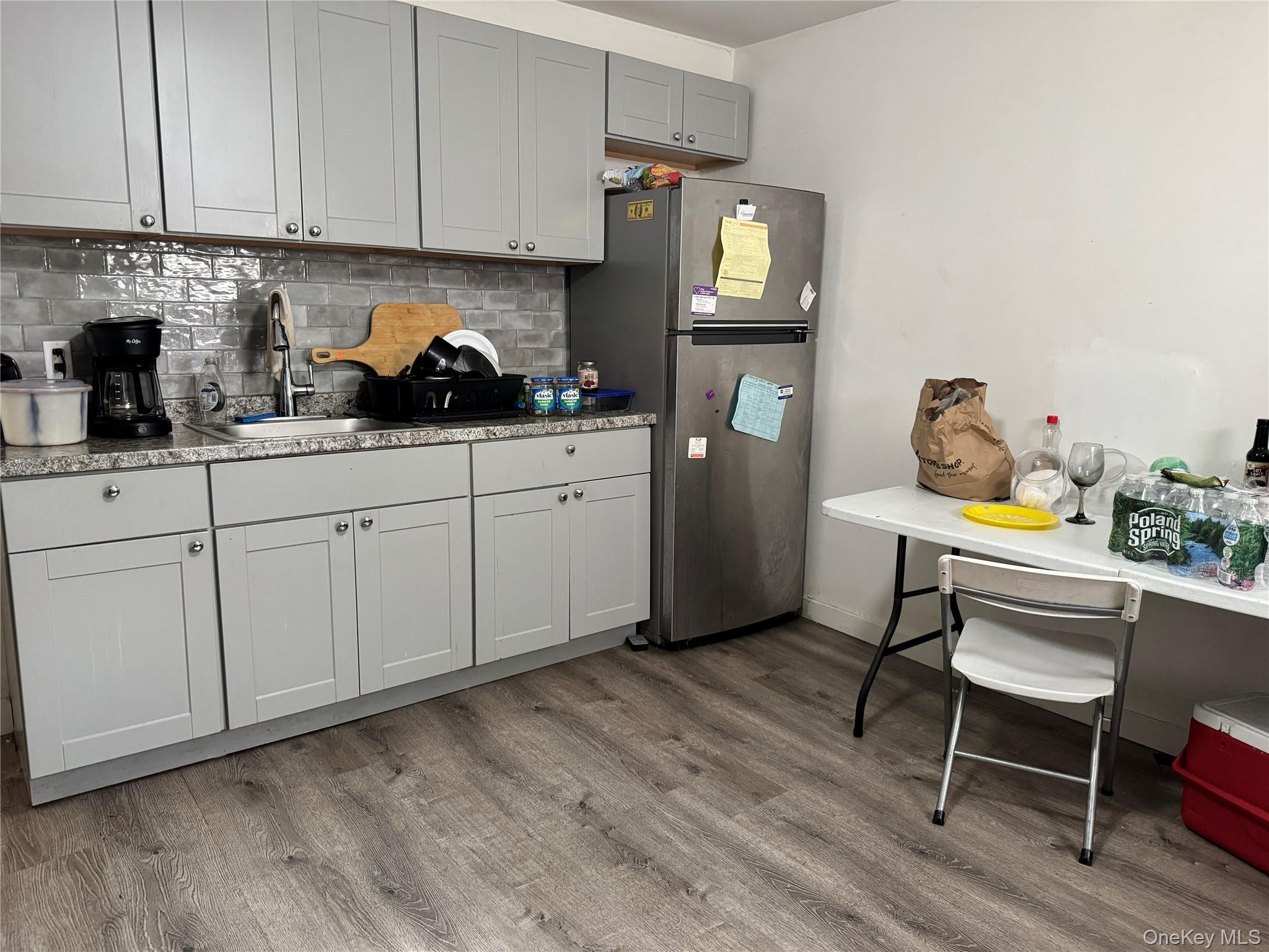 58 State Street Ossining, NY 10562 - Photo 10 of 11 a kitchen with stainless steel appliances granite countertop a table chairs stove and cabinets