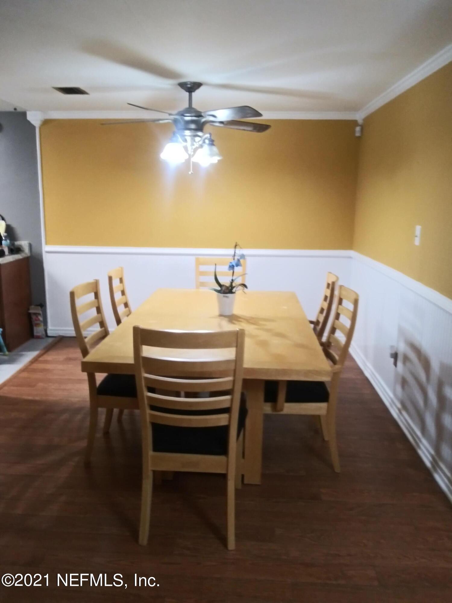 4245 Springwood Road Jacksonville, FL 32207 - Photo 4 of 12 a view of a dining room with furniture and chandelier
