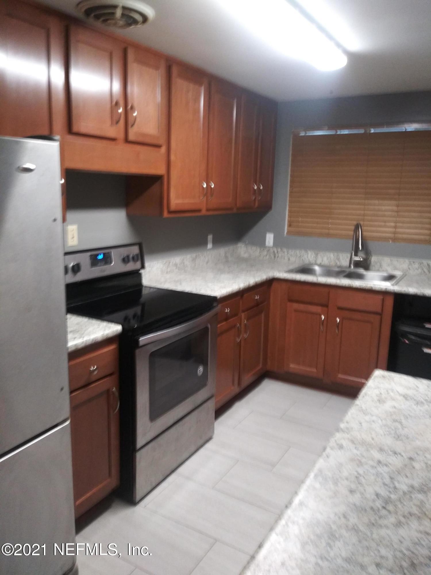 4245 Springwood Road Jacksonville, FL 32207 - Photo 5 of 12 a kitchen with granite countertop stainless steel appliances and sink