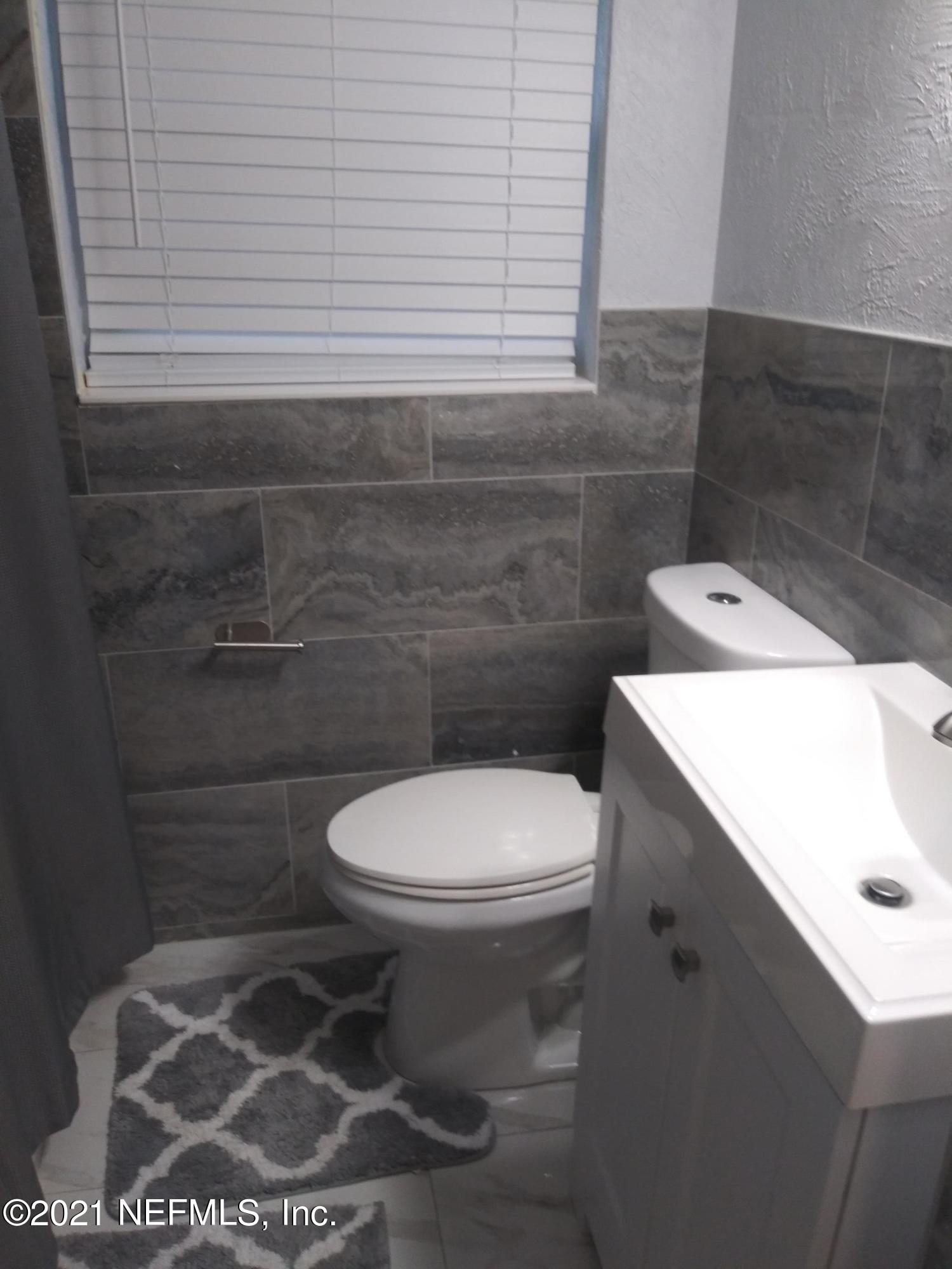 4245 Springwood Road Jacksonville, FL 32207 - Photo 10 of 12 a bathroom with a toilet a sink and a window