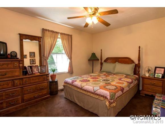 978 Cove Road Rutherfordton, NC 28139 - Photo 11 of 24 a bedroom with a bed and a chandelier