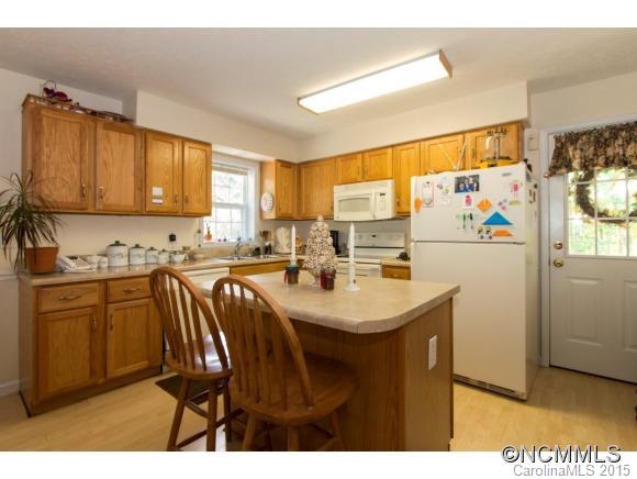 978 Cove Road Rutherfordton, NC 28139 - Photo 8 of 24 a kitchen with refrigerator and cabinets