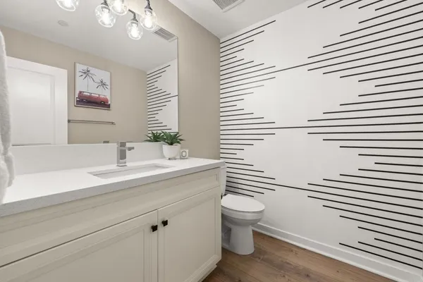 a bathroom with a sink a toilet and mirror