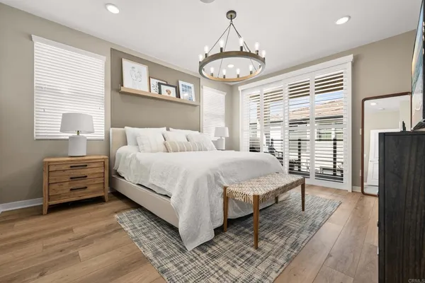 a spacious bedroom with a bed and a large window