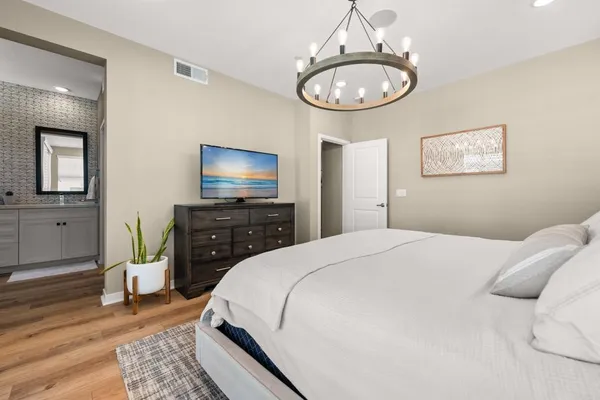 a bedroom with a bed and wooden floor