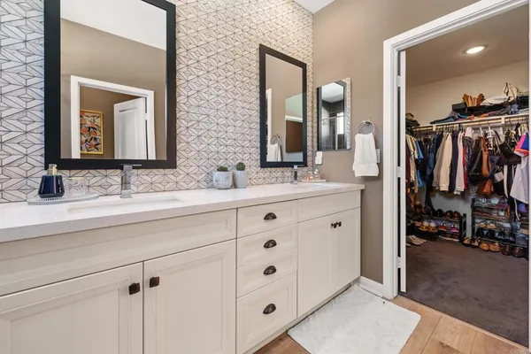a bathroom with a double vanity sink and a mirror